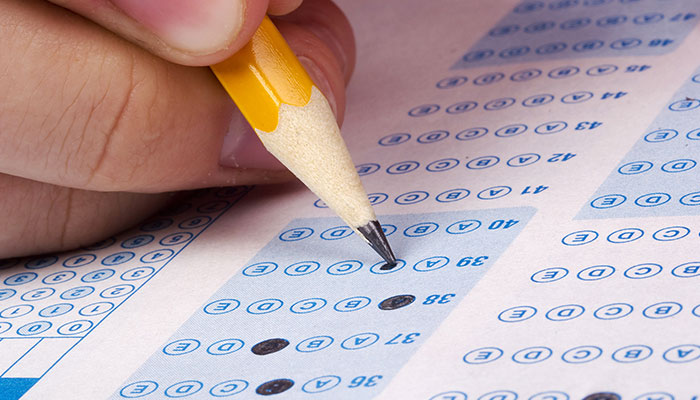student using pencil to fill in test form